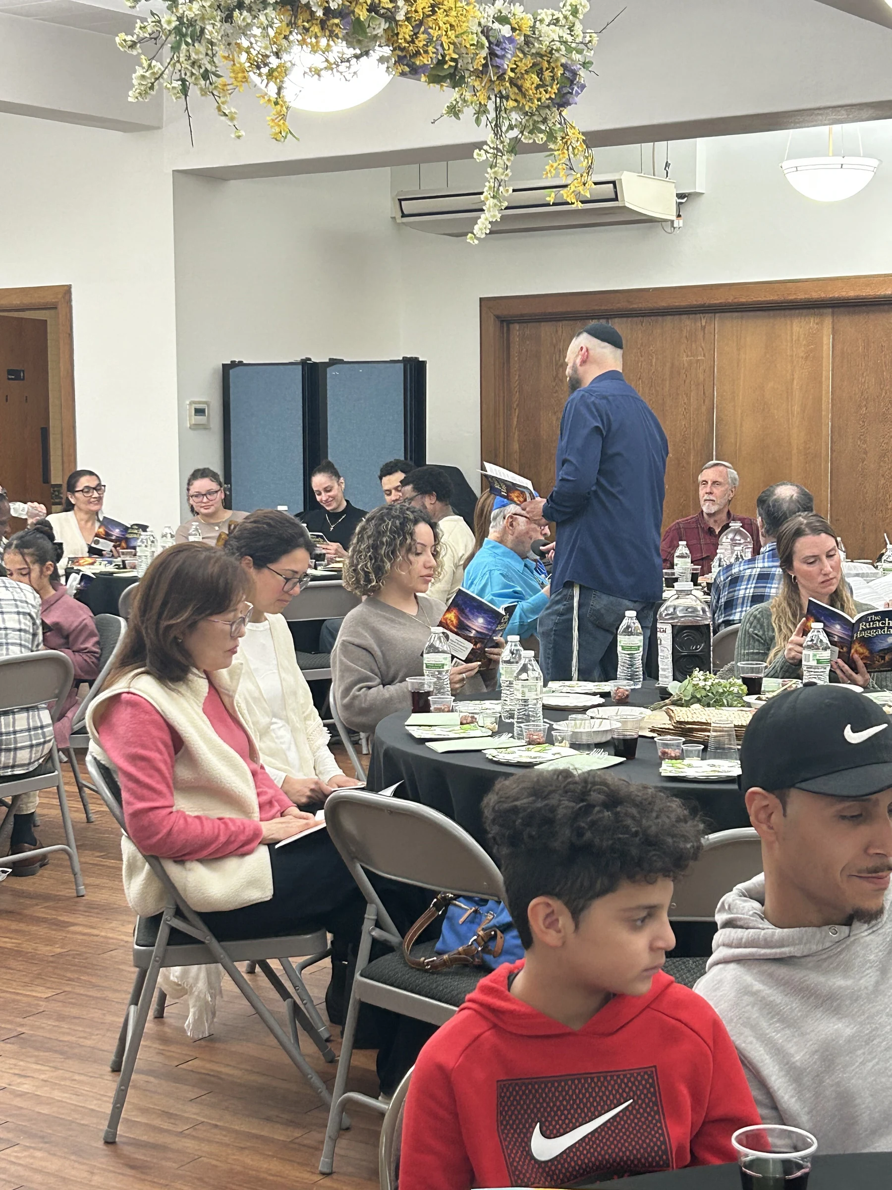 Members of Upper Room NYC sharing a fellowship meal after a Shabbat gathering