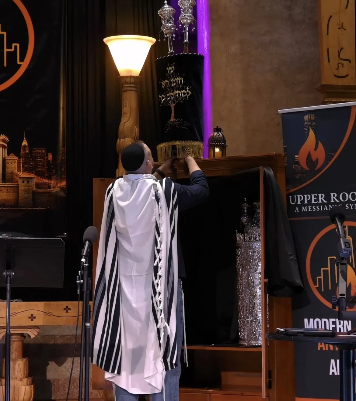 Lifting the Torah scroll during Shabbat morning at Upper Room NYC
